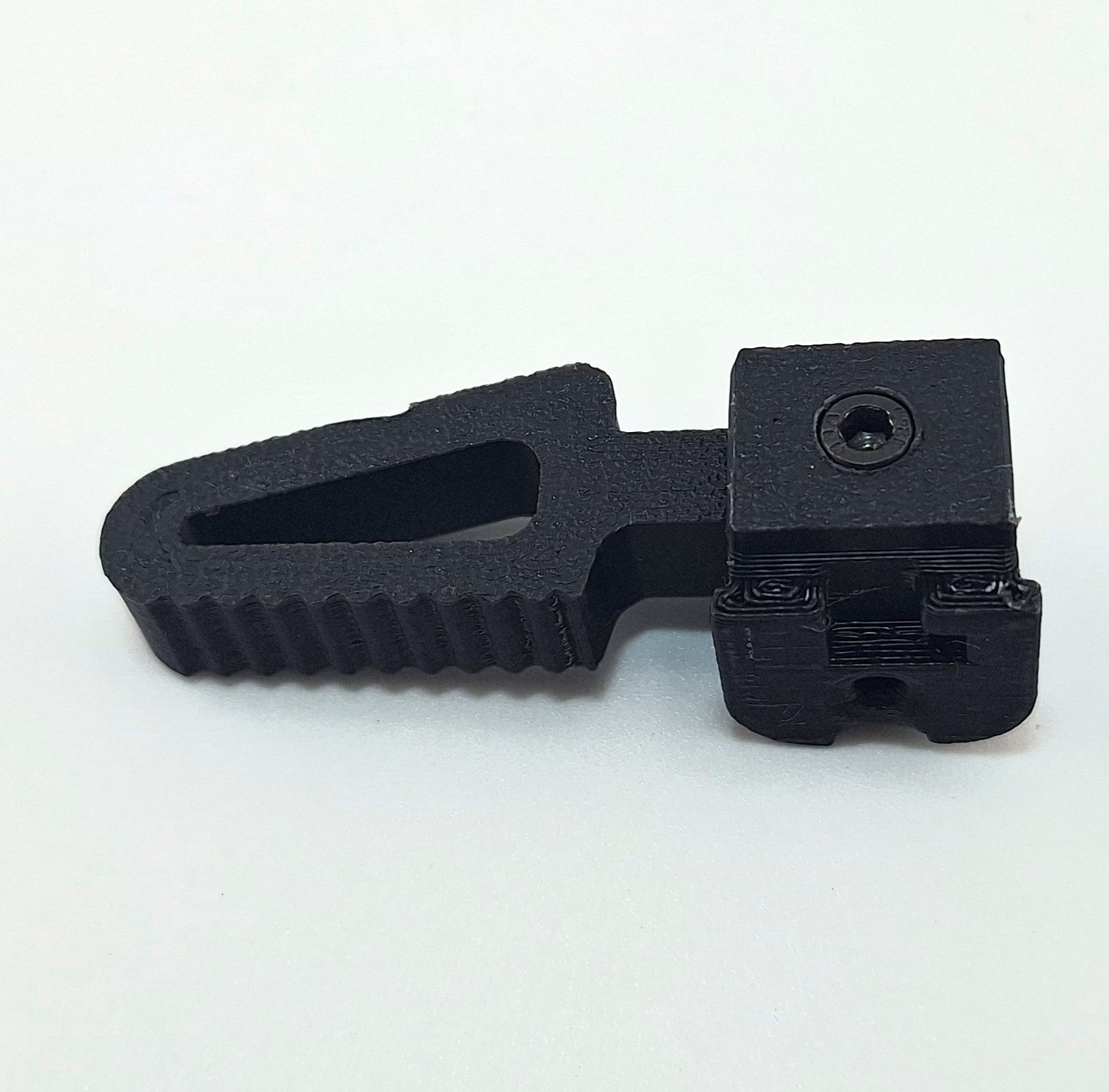 Close-up of black TX22 MTN charging handle component for firearm upgrade