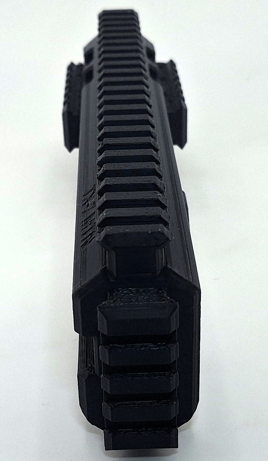 Close-up view of the black TX22 MTN Chassis with modular rail system for improved stability and accessory mounting.